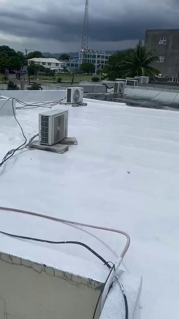 Membrane roof after silicone overcoat — sealed white finish