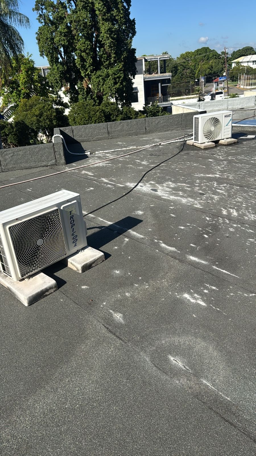 Torch-on membrane roof before — dark and ageing