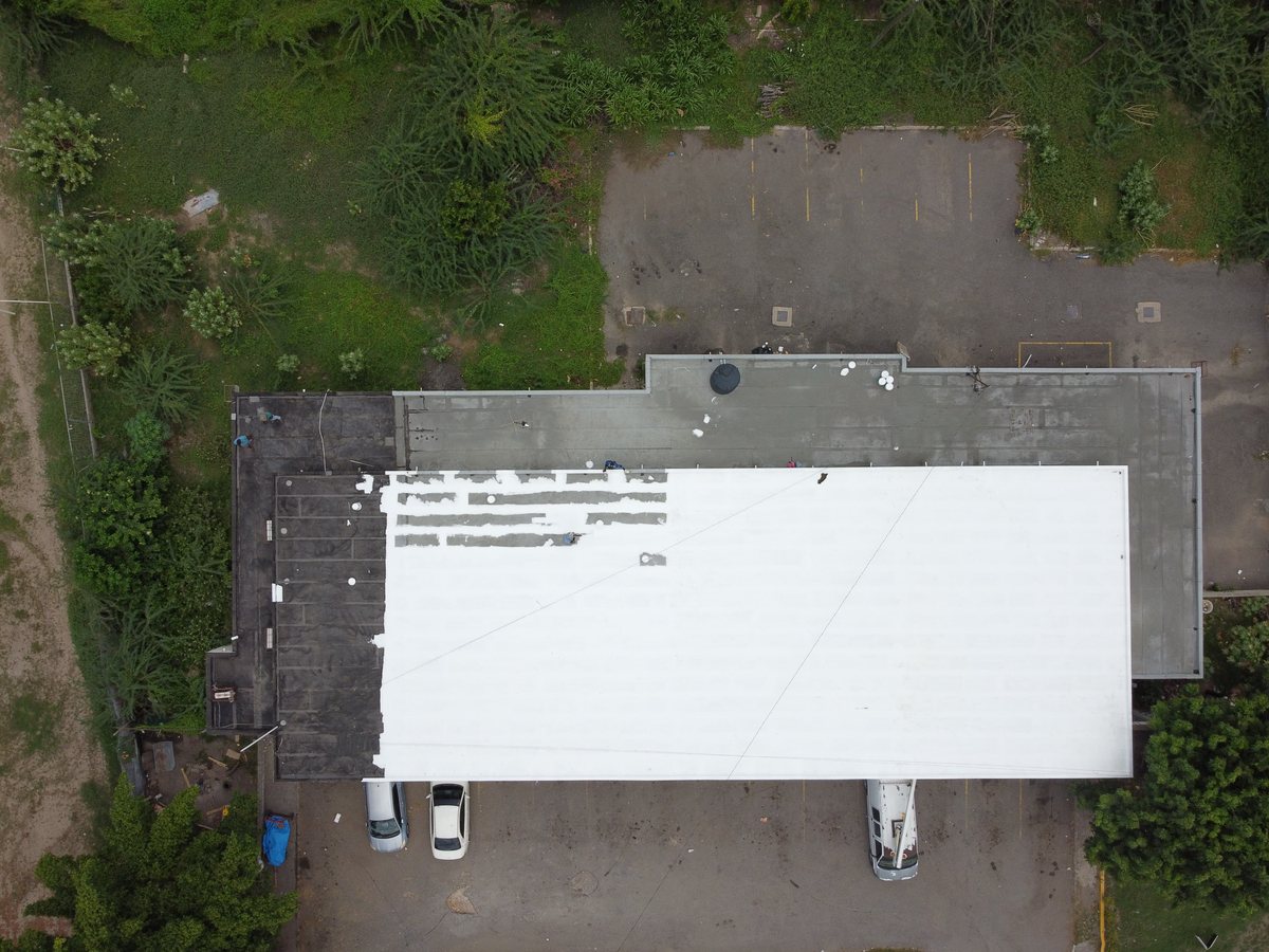 Membrane roof after silicone overcoat — sealed white finish